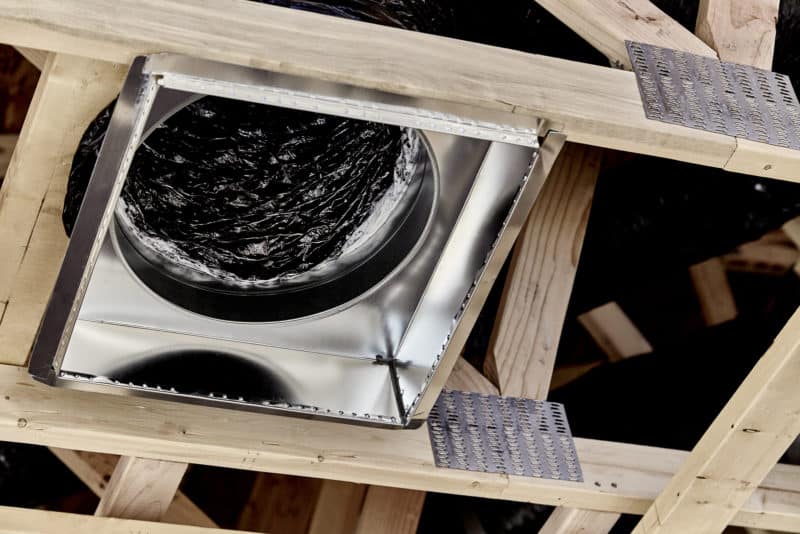 A stove in the middle of a wooden frame.