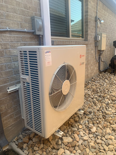 A small air conditioner sitting outside of a building.