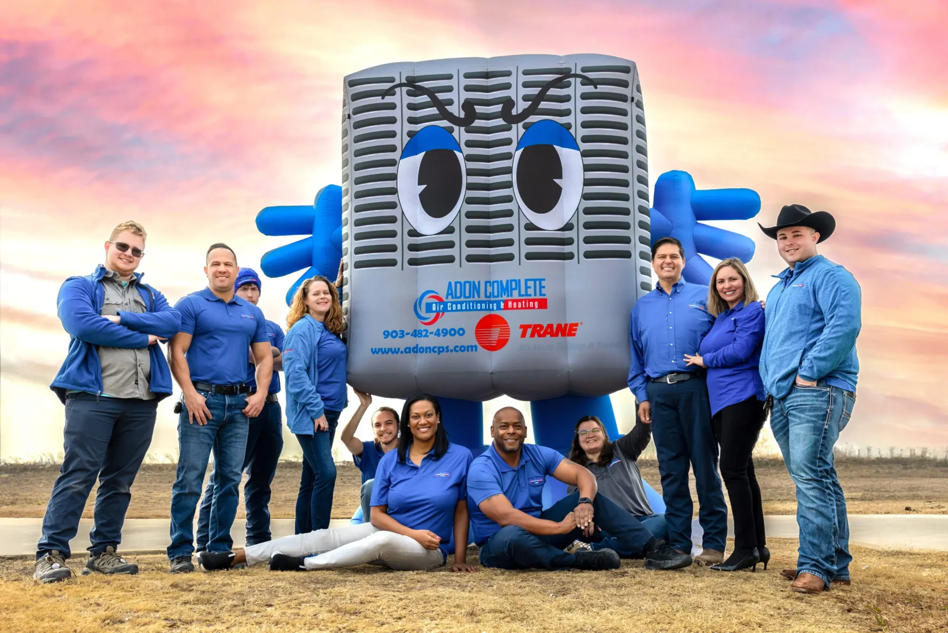 AC Installation with a bunch of people standing for a picture.