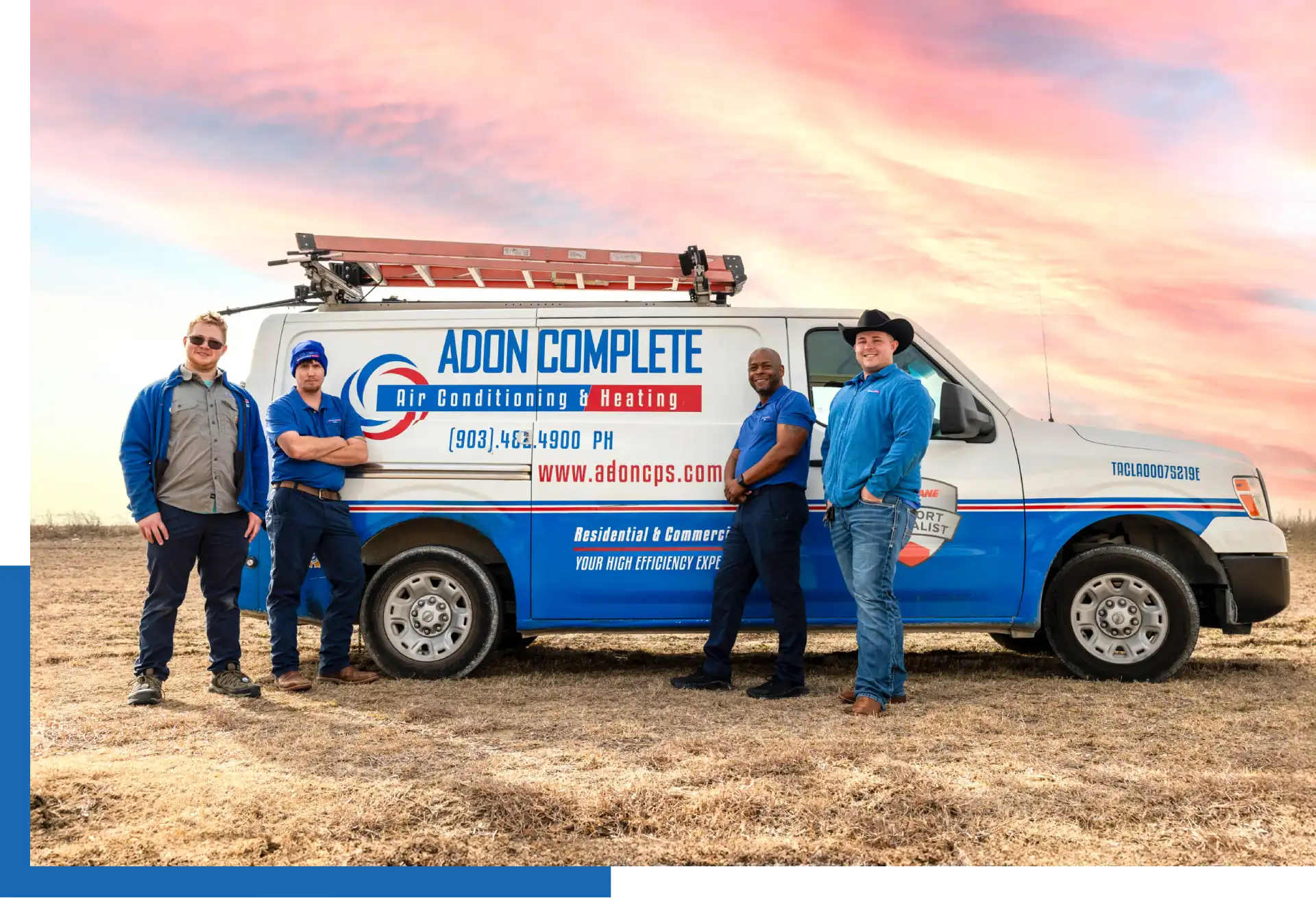 HVAC technicians standing by work van.