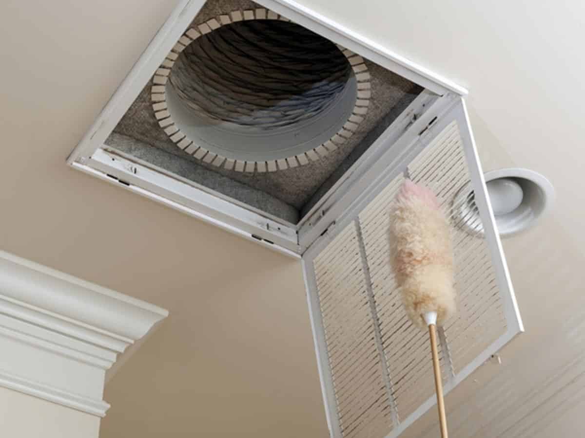 A dusting brush is on top of the air vent.